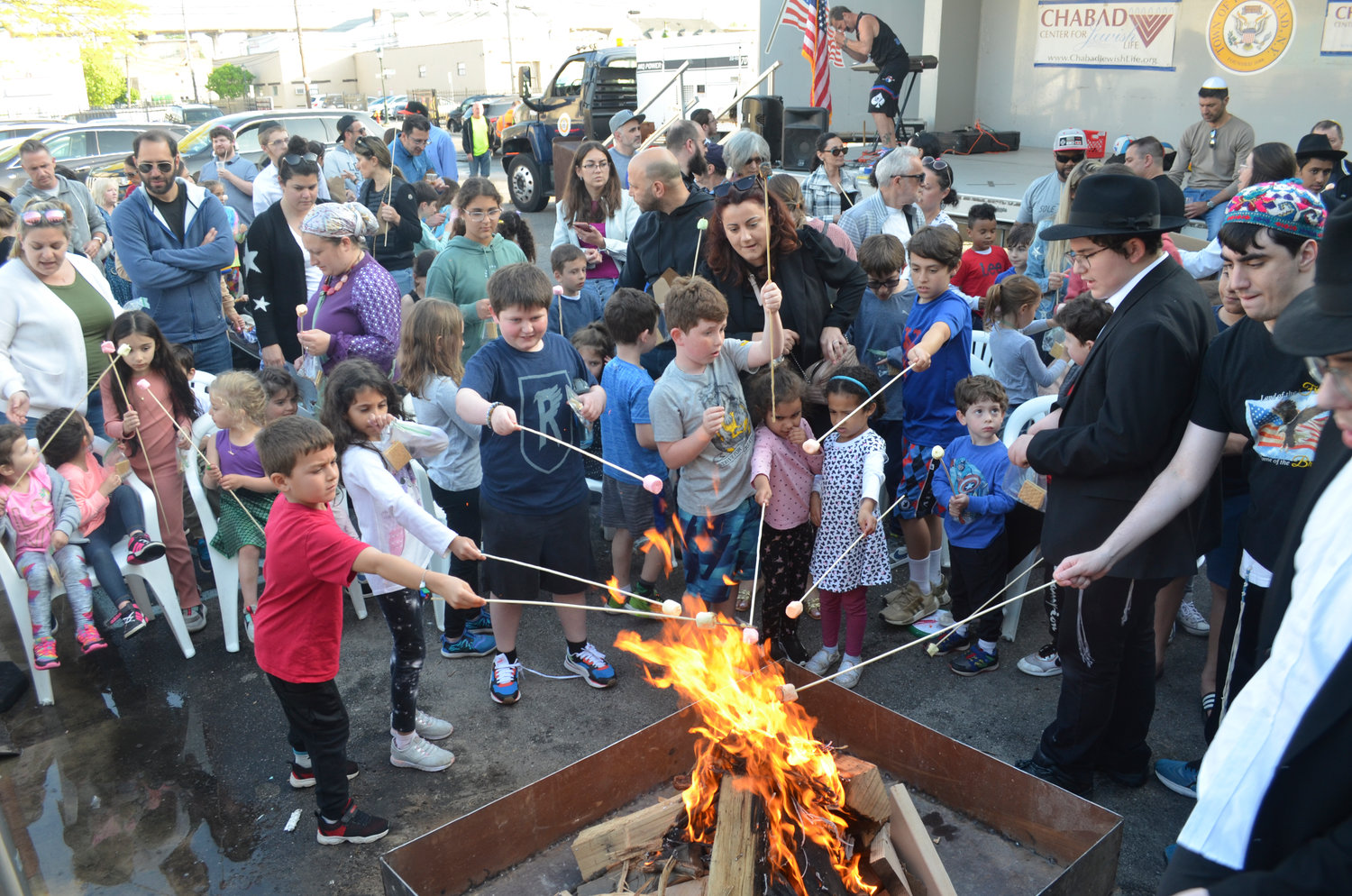 The community gathered around the bonfire to roast marshmallows.