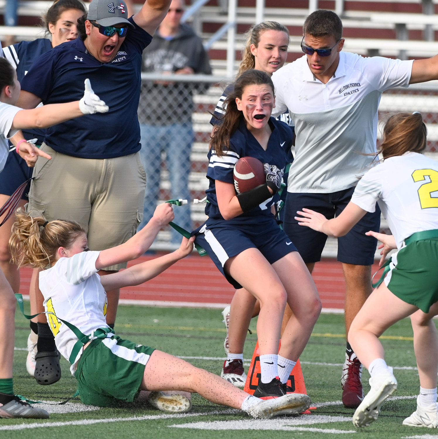 Bellmore-Merrick's Gabrielle Hanellin crossed the goal line for the winning touchdown a split second before Lynbrook's Kaelyn O'Brien, left, removed her flag in Thursday's county championship game.