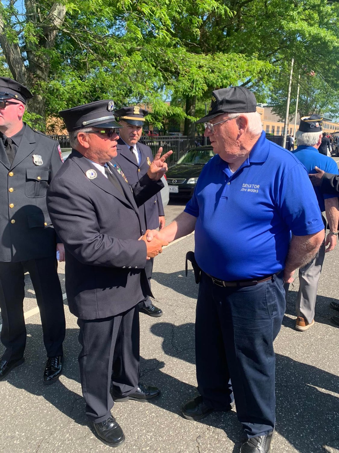 State Senator John E. Brooks greeted an official of the Freeport Fire Department on Memorial Day. Brooks has been state senator for District 8 since 2016, but under the redrawn district lines, will not run to fill the seat of the new District 5.