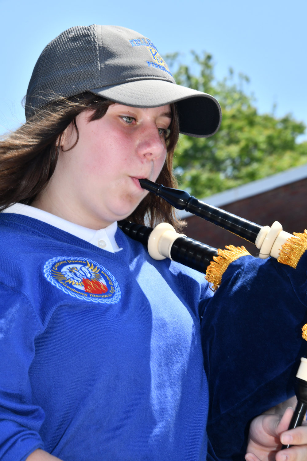 Bagpipe player Catherine Lewis passed the reviewing stand.