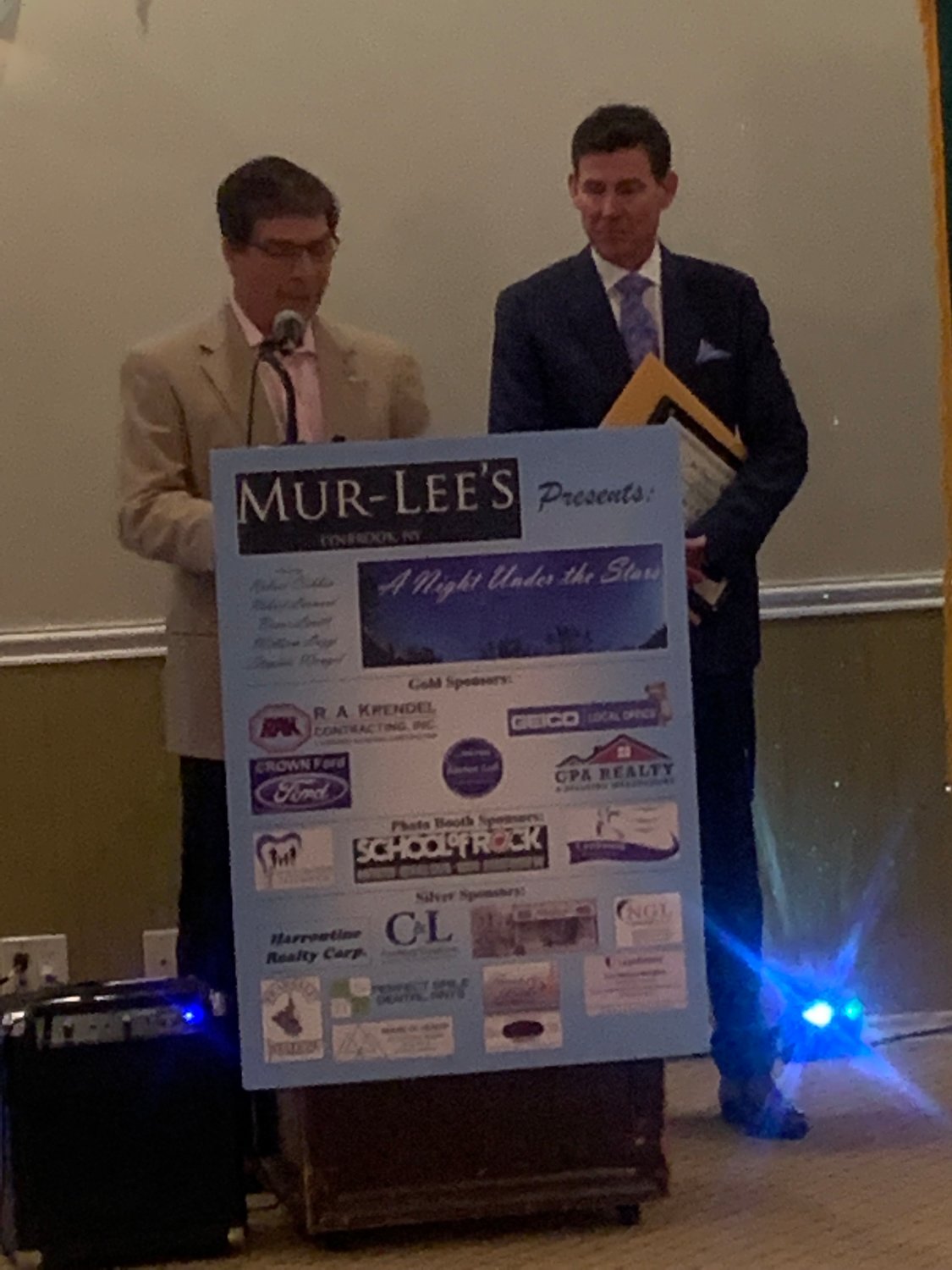 Lynbrook Mayor Alan Beach, left, presented business owner Bruce Levitt with his award.