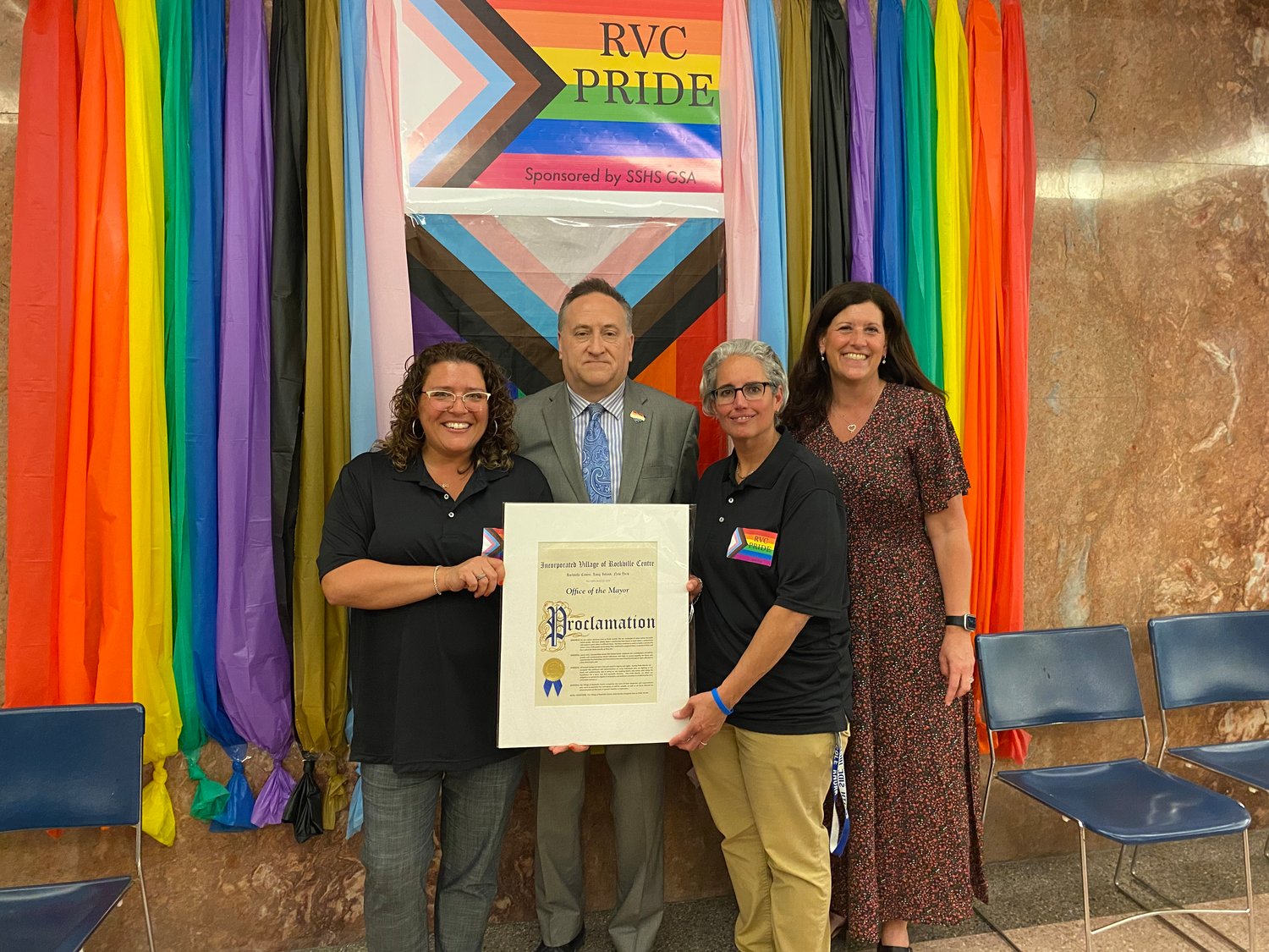 Christine Brown, left, and Nicole Knorr, second from right, of the Gay/Straight Alliance, and the Rev. Scott Ressman ushered in Pride Month with Deputy Mayor Kathleen Baxley, far right.