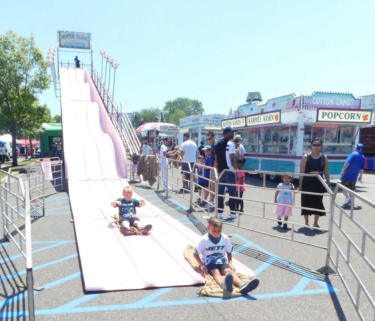 Families lined up for a fast ride down a high slide at the Nautical Mile Festival last Saturday, June 4.