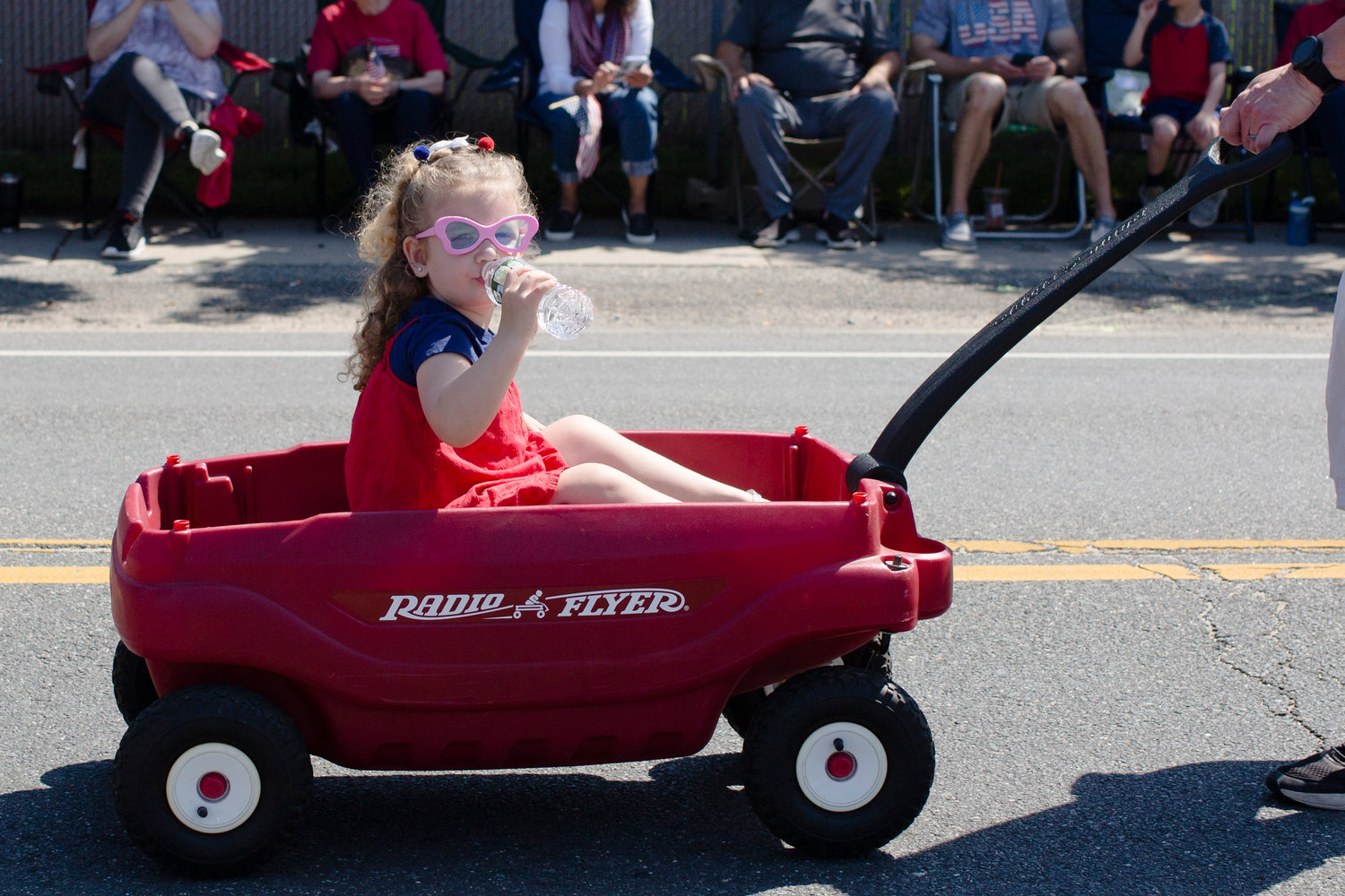 Finley Ahnnam (3) from Oceanside getting a ride at the Oceanside Memorial Day Parade on Monday, May 30th 2022.