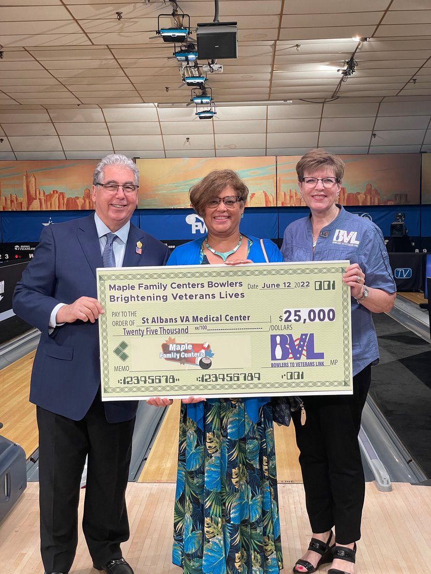 Maple Lanes owner John LaSpina, left, and BVL Executive Director Mary Harrar awarded Yvette Cintron, of the St. Albans VA Medical Center, a check for $25,000.