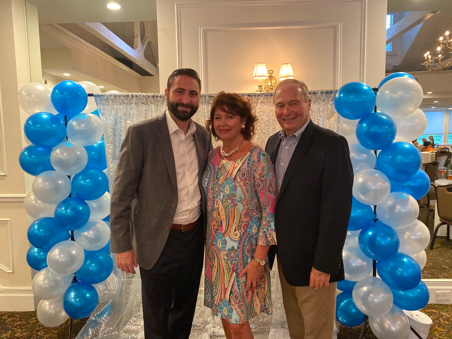 Carol Lombardi, center, celebrated her retirement after 27 years teaching at St. Mark’s with her son Kevin, left, and husband Bruce, right.
