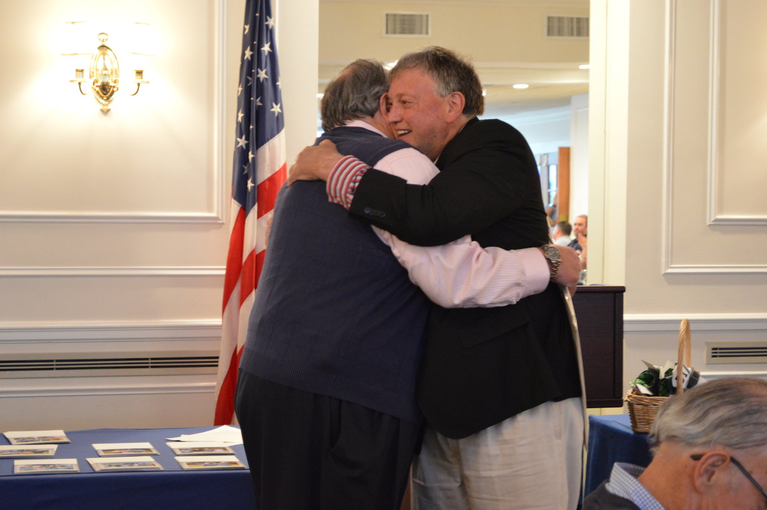 Old friends Mayor Murray and honoree Brian Joesten embrace before the crowd at the Rockville Links’ dining hall.