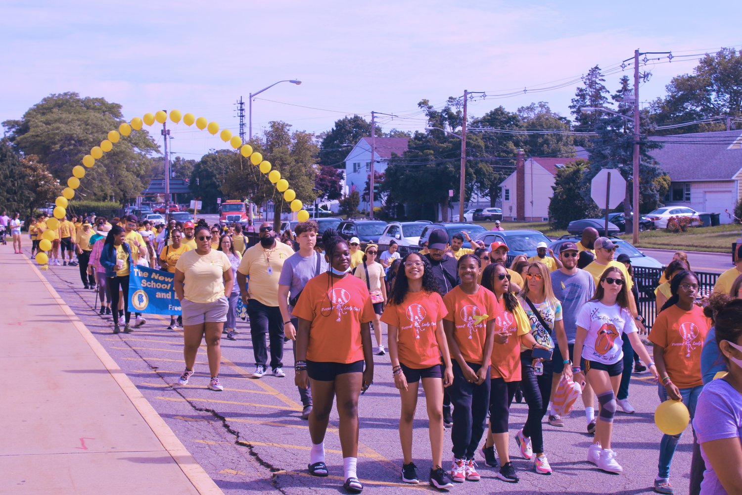 Participants in the 13th Annual Freedom Cares Peace March streamed through an arc of yellow balloons as they started their route on Saturday morning.