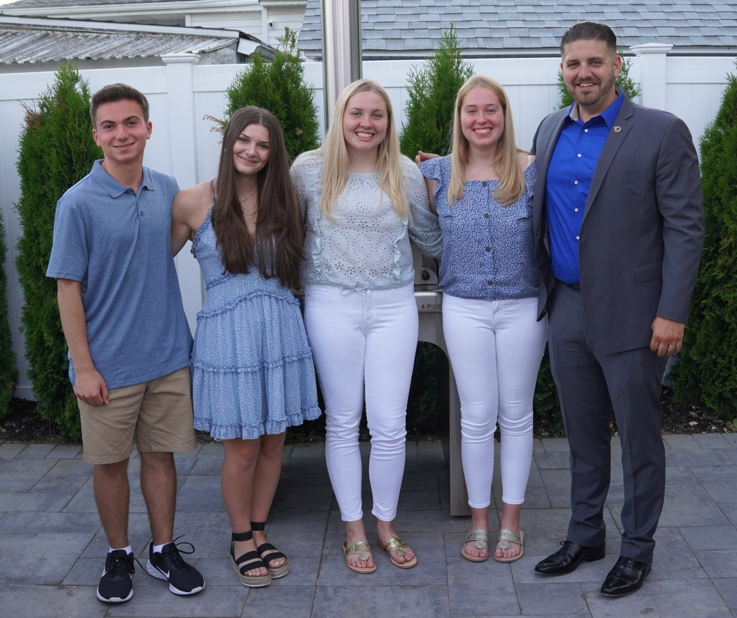 From left, Christopher Ignatiou, Victoria Buffolino, Ella Noonan, and Brooke Noonan were awarded scholarships from Chamber President Richie Krug Jr.