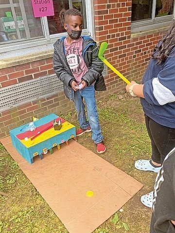 Miniature hockey goals test a student’s delicate motor skills at Northern Parkway School's Cardboard Carnival in Uniondale.