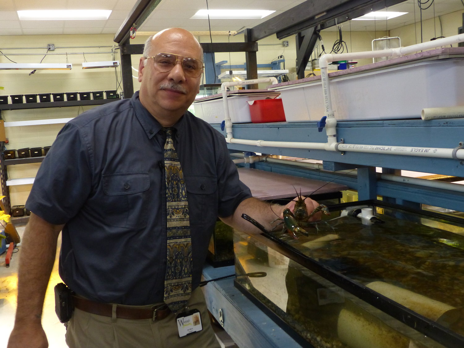 Salvatore Mule holds “Sid,” an Australian red-clawed crayfish used in his class’s aquaponics.