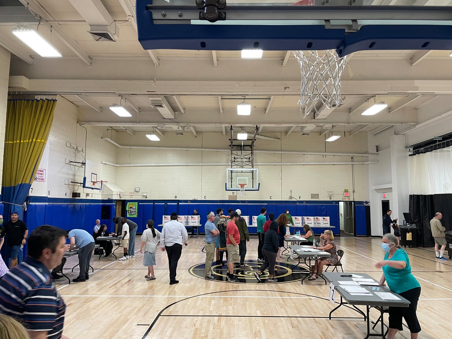 The last few voters filter into the West Hempstead Middle School gymnasium.