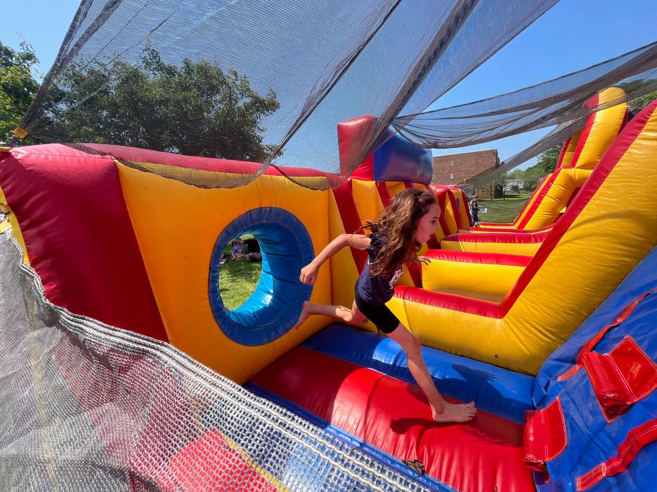 Third grade student Penelope Milillo ran her way through the bouncy obstacle course at Summer Jam.