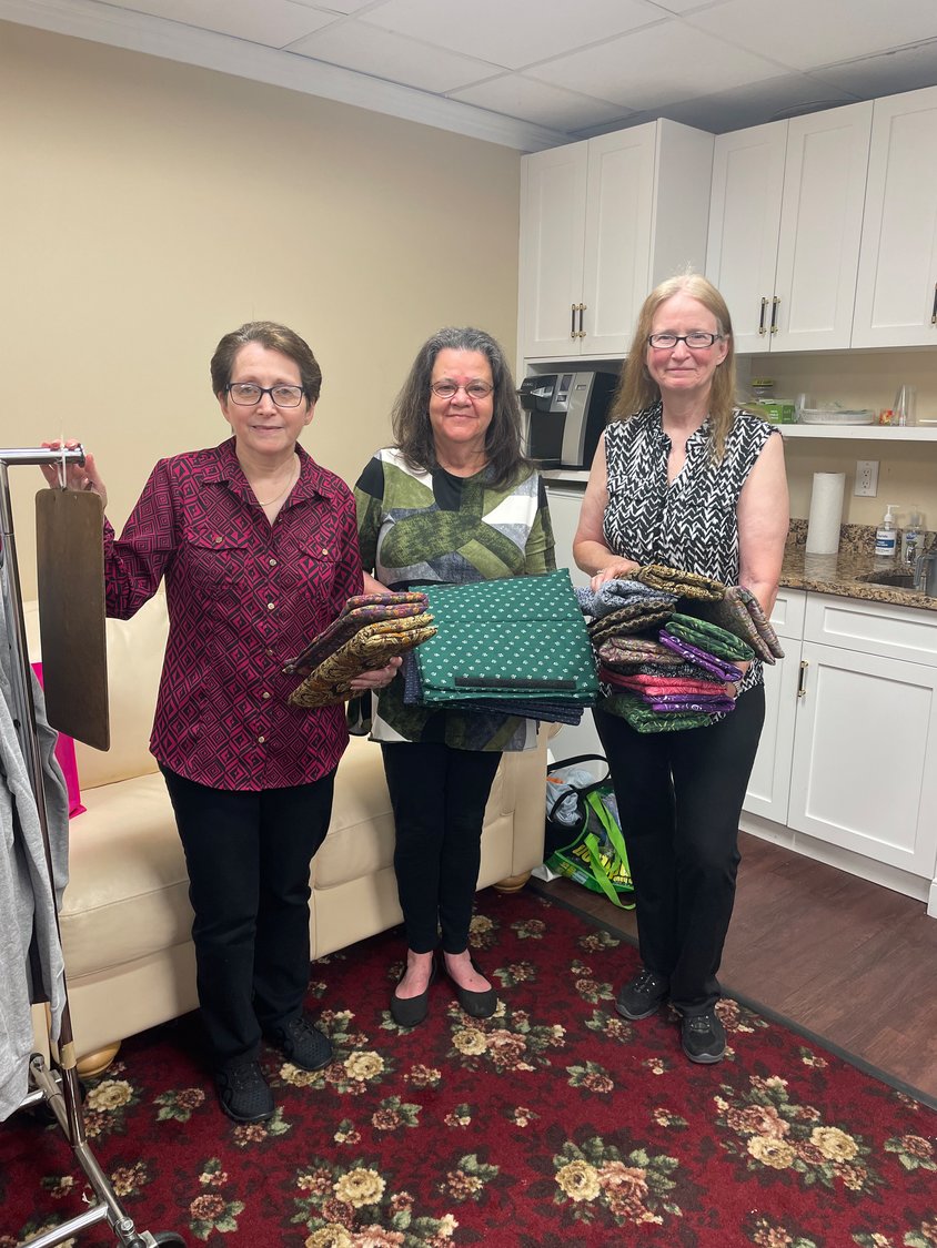 Loraine Alderman, founder of Dress for Recovery, joined Jane Hartigan and Catherine Peterson — members of the Evening Star Quilters organization — to donate 50 seatbelt covers for a good cause.