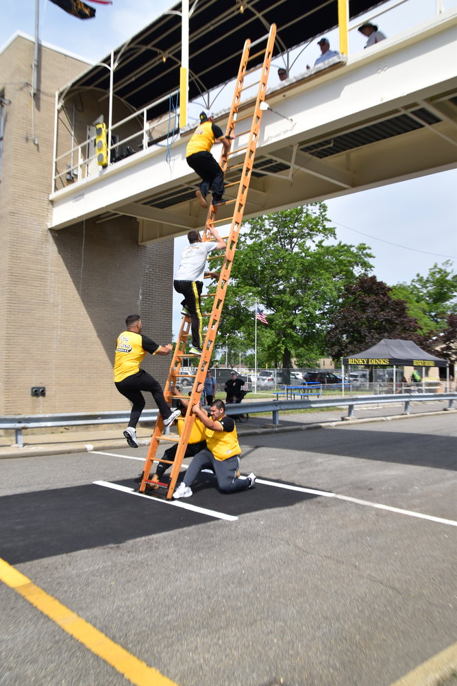 The North Bellmore Rinky Dinks head up a ladder during the ladder competition.