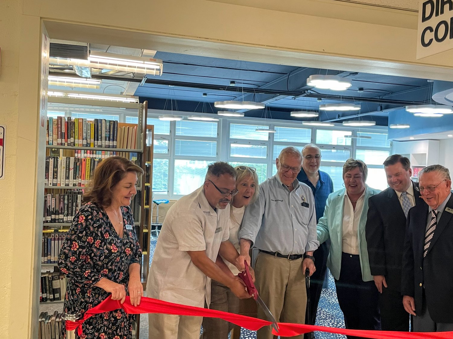 North Merrick Library Director Susan Santa, far left, with board President Mark Davis, Vice President Kristin Frost, State Assemblyman Dave McDonough, William Pezzulo, Hempstead Town Clerk Kate Murray, County Legislator Thomas McKevitt and William C. Smith at the Teen Room ribbon-cutting ceremony.