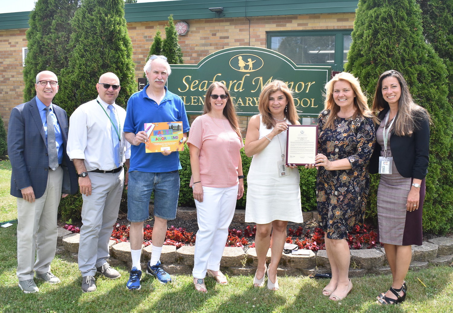 In June 2021, Seaford Manor Elementary School earned distinction as an International Habits of Mind Learning Community of Excellence, recognized by the Institute for Habits of Mind. From left were Director of Humanities Charles Leone, Deputy Superintendent John Striffolino, Board of Education President Bruce Kahn, Trustee Stacie Stark, Superintendent Adele Pecora, Principal Debra Emmerich, and Assistant Principal Mary-Ellen Kakalos.