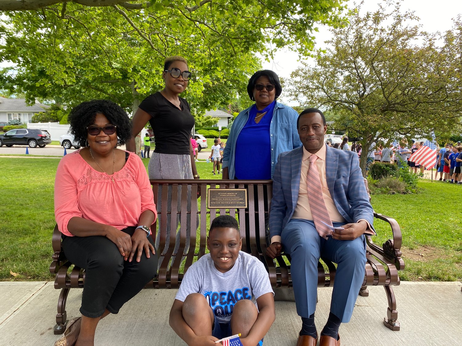 From left, Pansy Matthews, Simone Tibbetts, Jonathan McKenzie, Jennifer McLaughlin, and Stanley McKenzie surrounded the bench dedicated to their beloved family member, Andrea McKenzie.