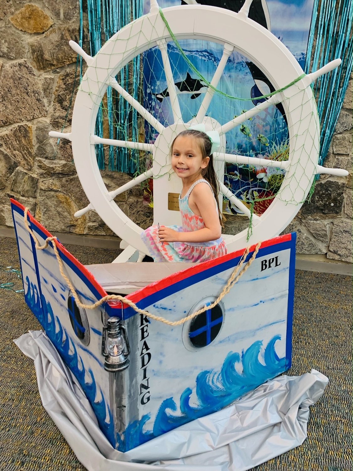 A young reader attendings the Dive Into Summer Reading: Oceans of Possibilities kick-off event on June 11.