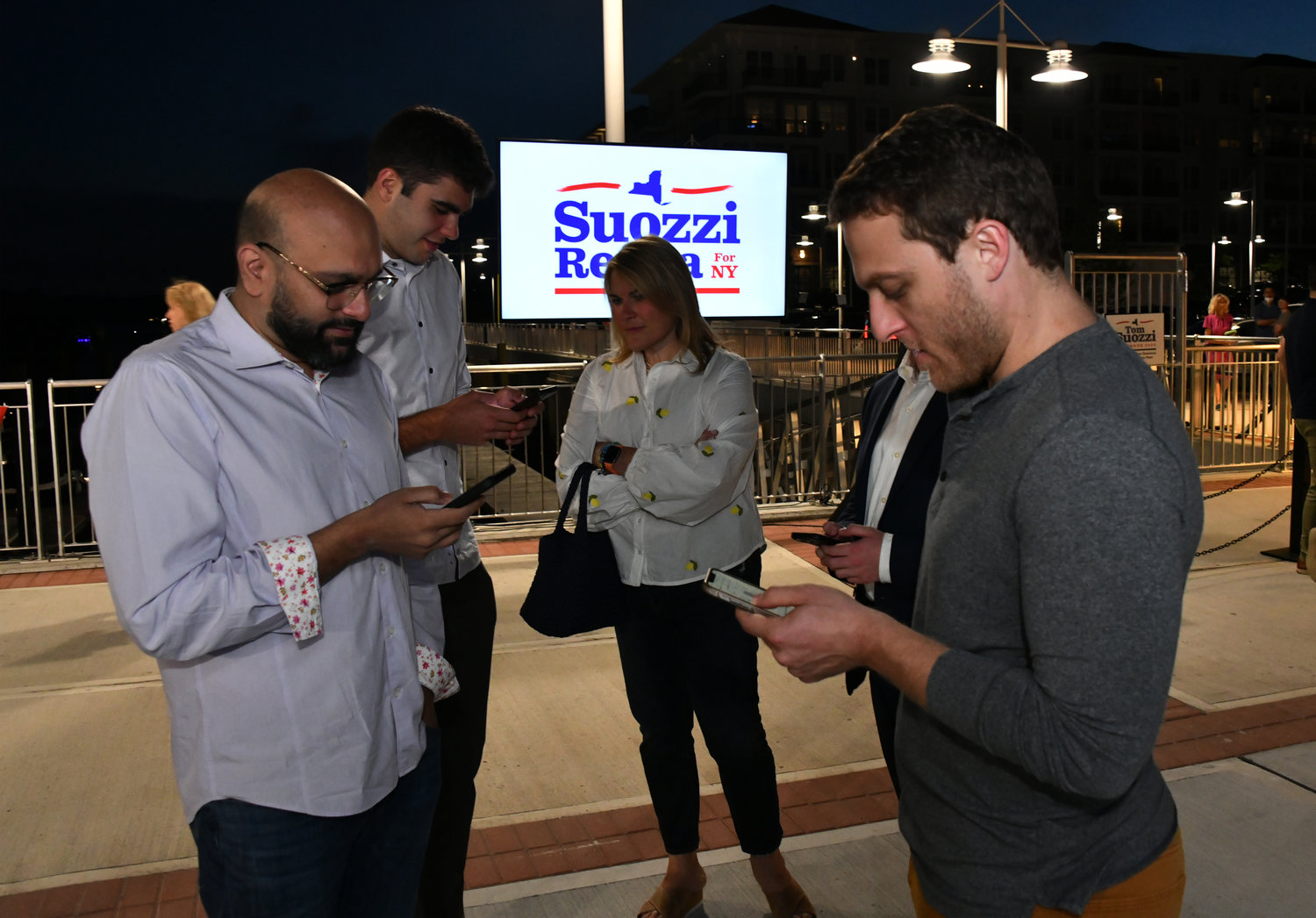 Volunteers from Tom Suozzi’s campaign anxiously checked their phones for the latest poll results.