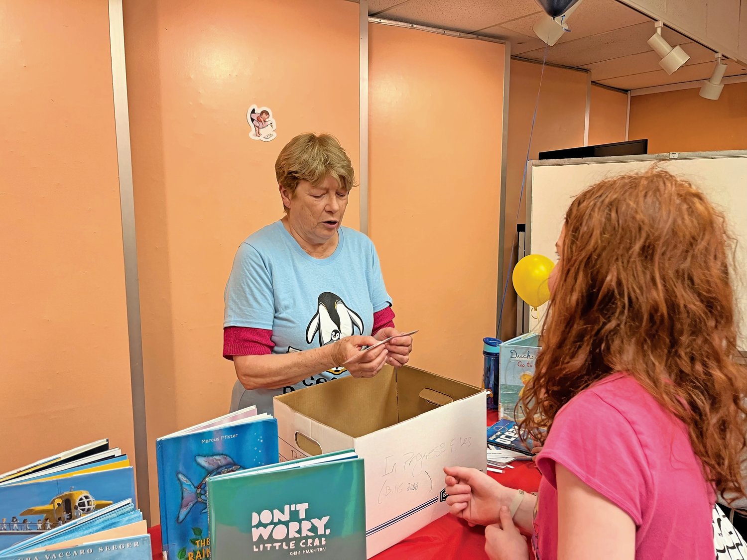 Pat Murphy, the children’s librarian at the Peninsula Public Library, asked trivia questions about the ocean during the Summer Reading Program kickoff party.