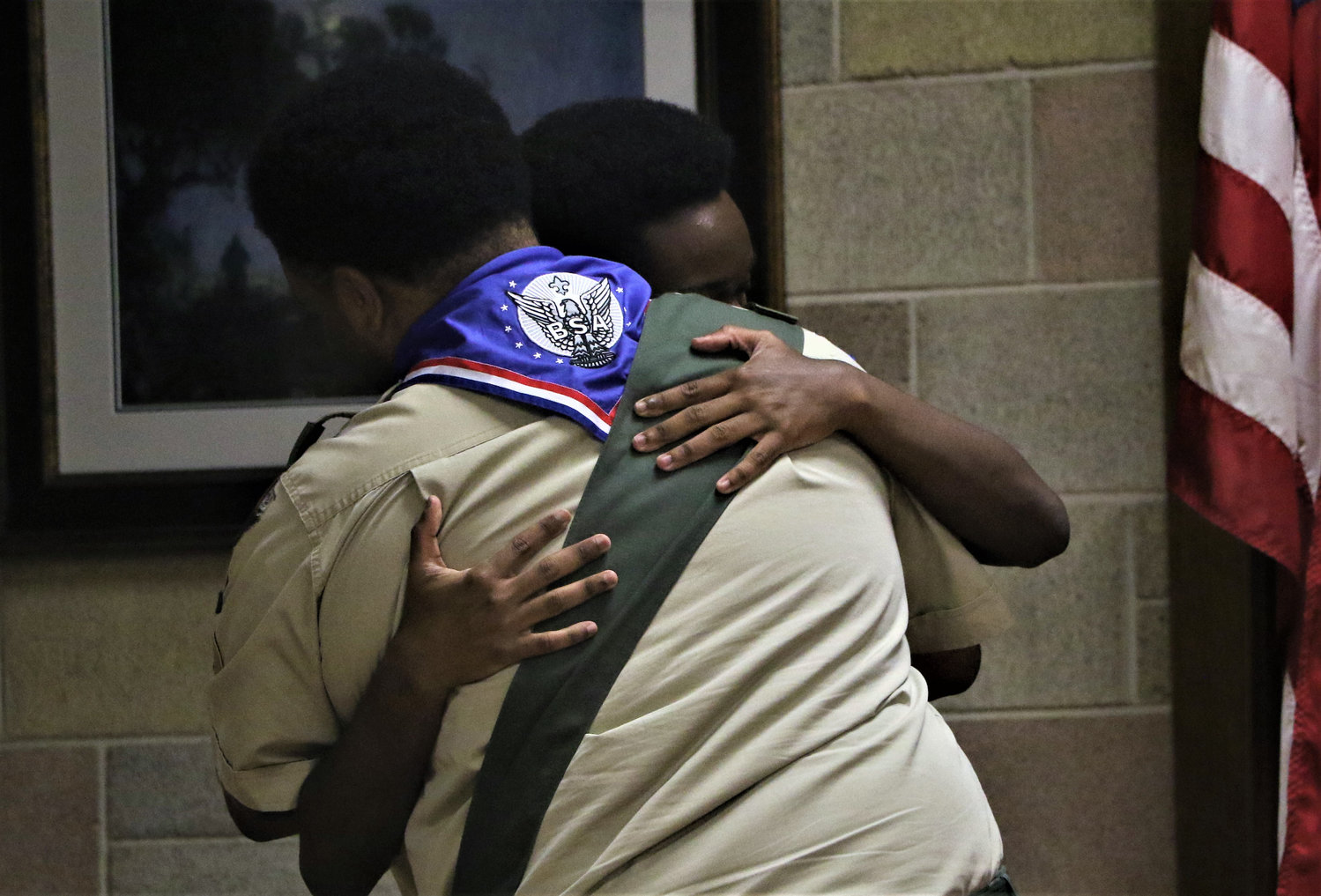 Master of Ceremonies and Eagle Scout Kenneth Bradley receives a big hug and thanks from his brother Trevor J. Bradley.