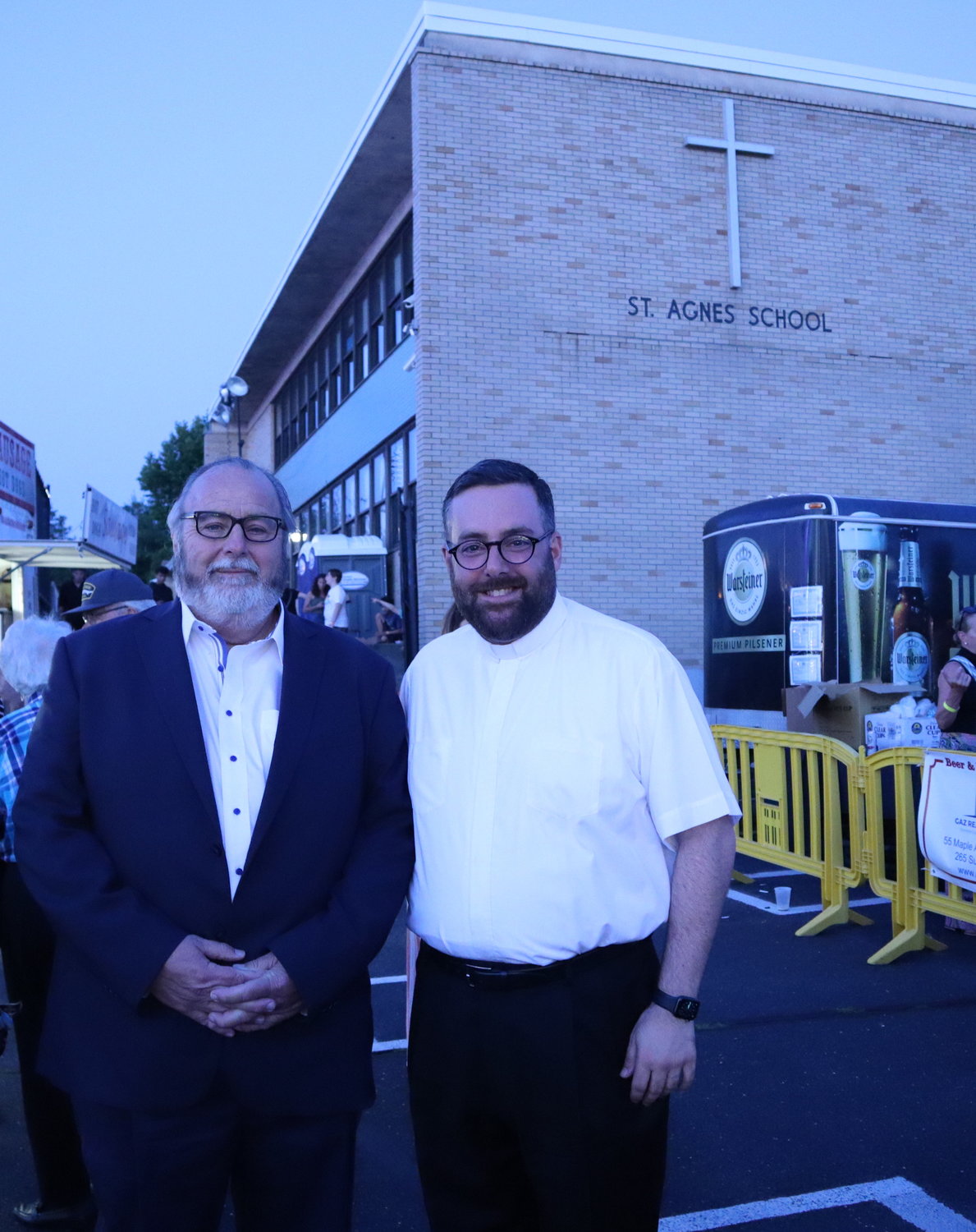 Rockville Centre Francis Murray and Father Michael Duffy enjoy the festivities in the St. Agnes Cathedral School parking lot.