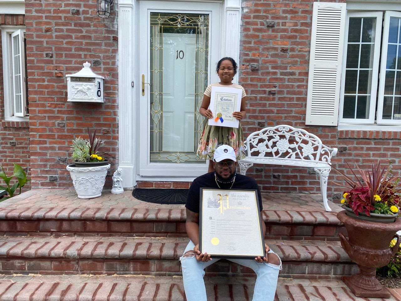 Lianna and her father at their Elmont home, where State Assemblywoman Michaelle Solages and her brother, County Legislator Carrié Solages, presented her with a proclamation honoring her for the strength and courage she displayed during her struggle with leukemia.