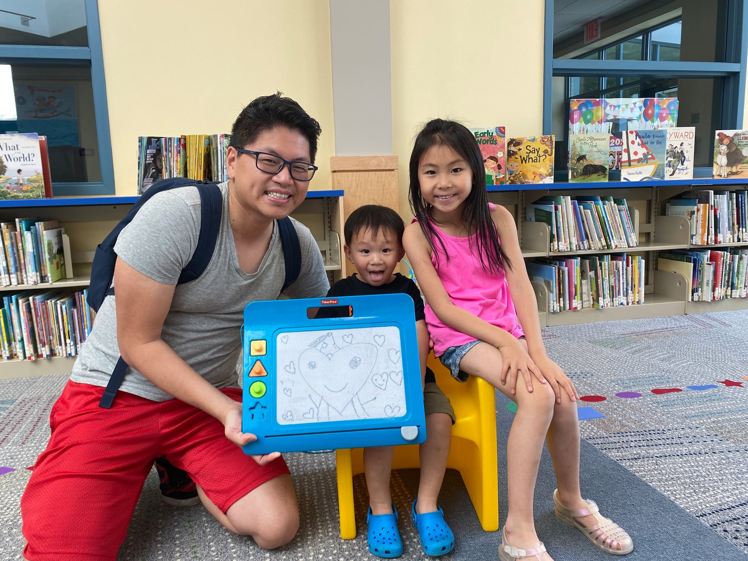 Beethoven Bong and his children Simon, 2.5, and Hope ,6, stopped by to enjoy the children's room in the library.