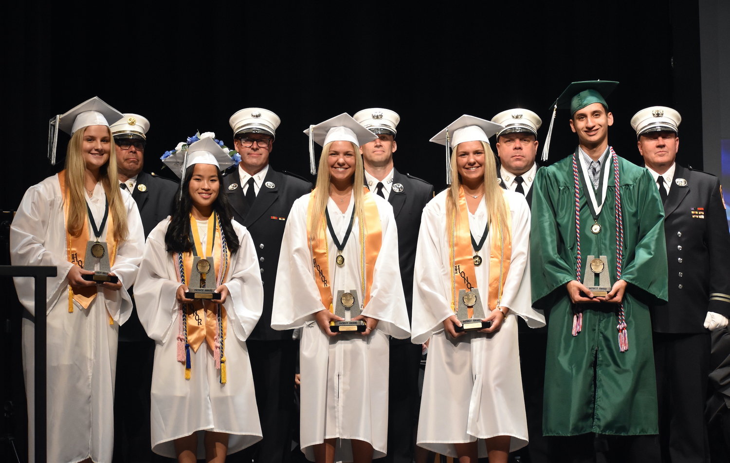 Seaford High School’s 2022 Patriot Award recipients were, from left, Alexandra Leggio, Annarose Romanelli, Brooke Surace, Parker Surace and Bryant Wong. An FDNY honor guard joined them after they received their awards at graduation on June 25.
