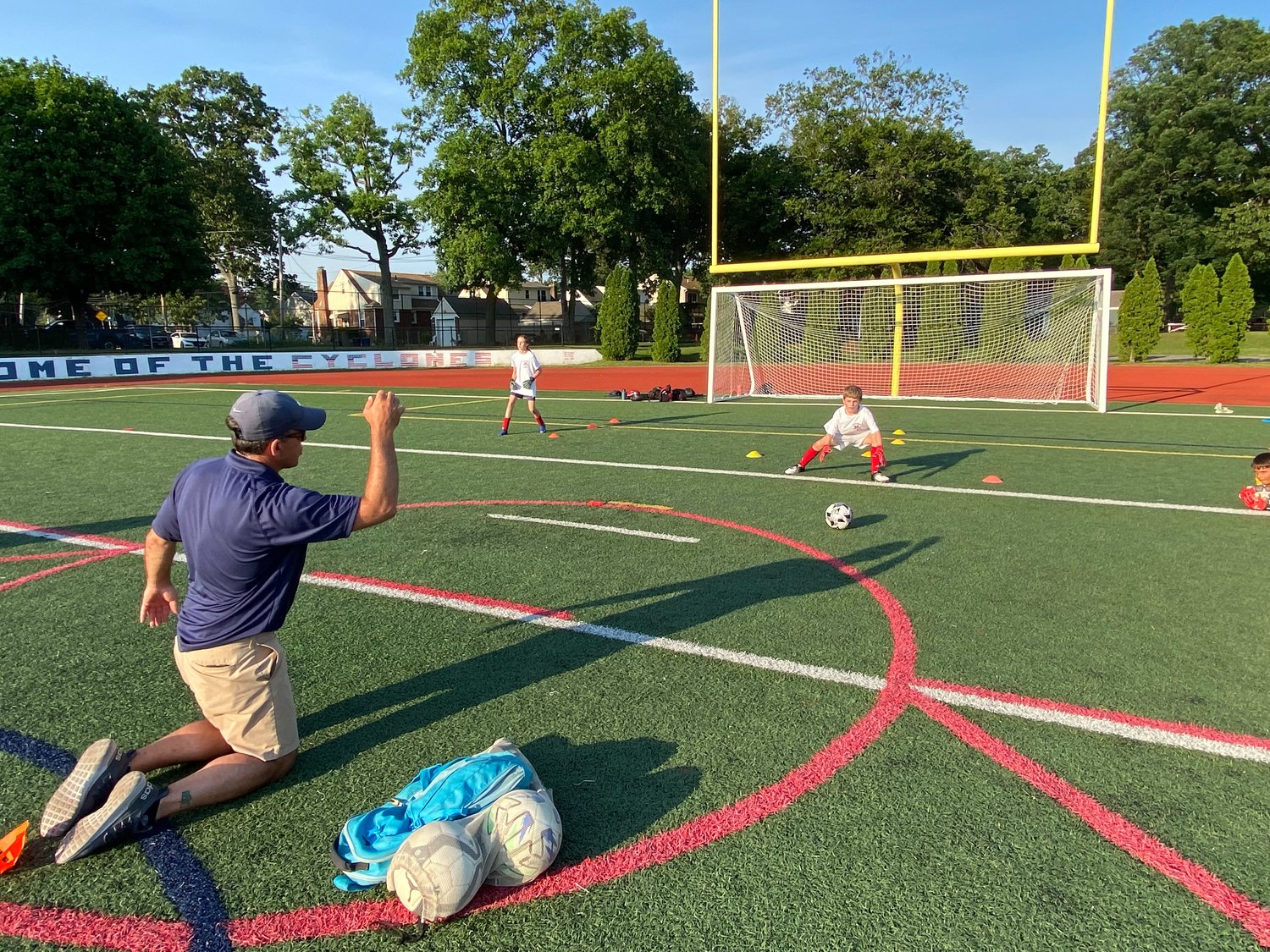 Coach Phelan works with the young goalkeepers.