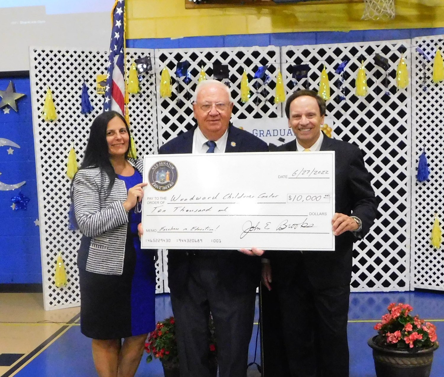 State Senator John Brooks, center, gave a donation of $10,000 to Woodward Children’s Center, which was received by Principal Danielle Colucci and Executive Director Greg Ingino.