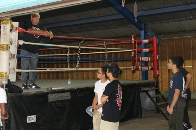 Giovanniello with his young boxing students, above left.