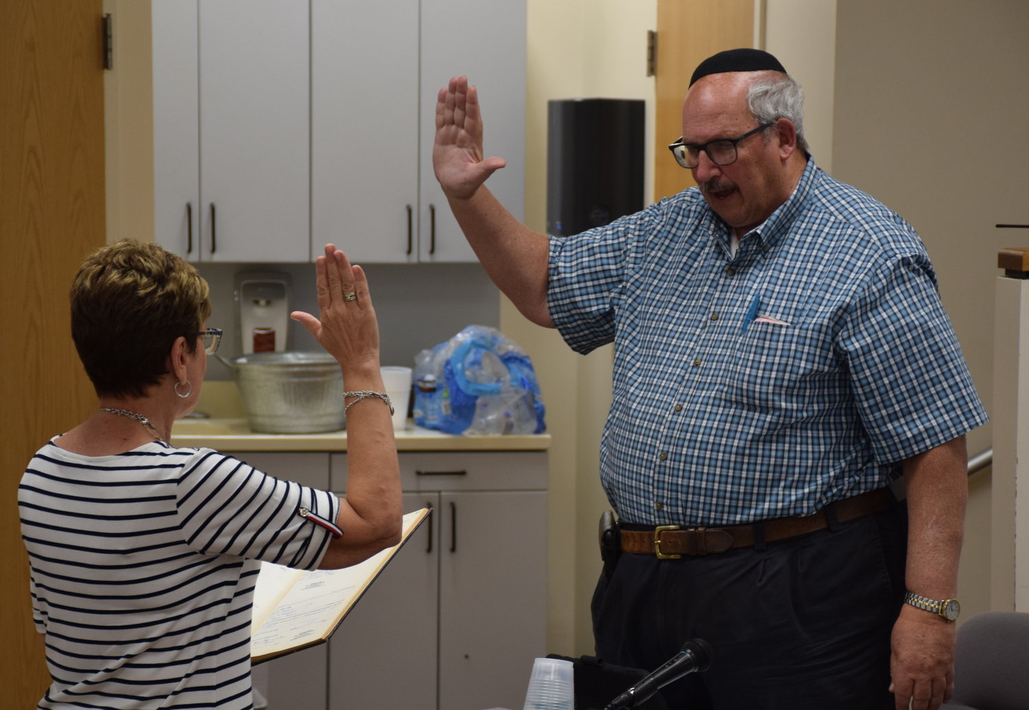 District clerk Theresa Bryant swore in Burt Blass as a new school board trustee at the board’s reorganization meeting.