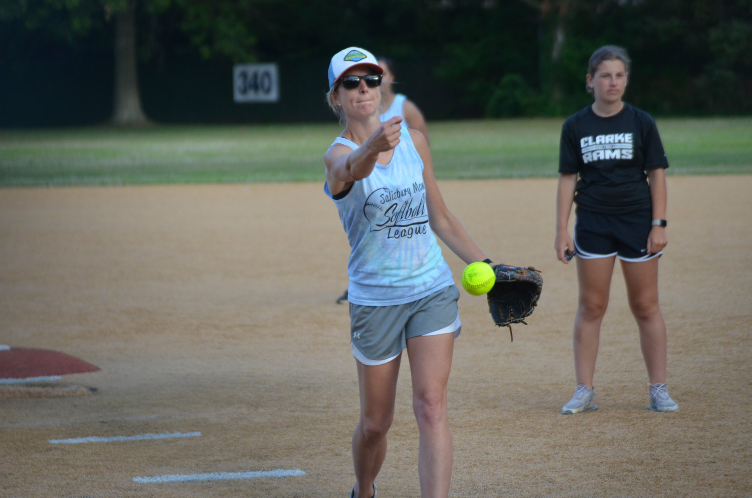 Kelsey Klimkowski pitches out a ball for their softball game on July 7 as Sydney Follick from W.T. Clarke High School umpires behind her.