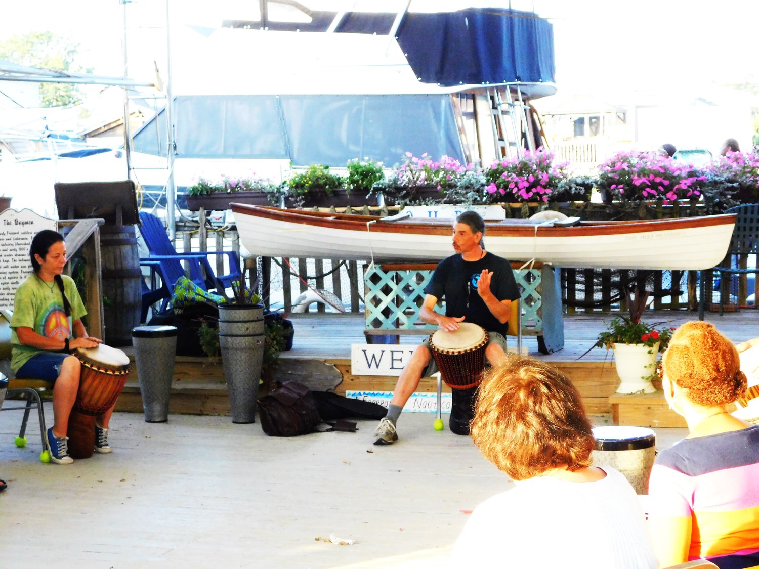George Schultze, center, guided a circle of djembe novices through an evening of rhythmic discovery on the Nautical Mile in the event space next to the Sparkle on Stage Cultural Arts Center.