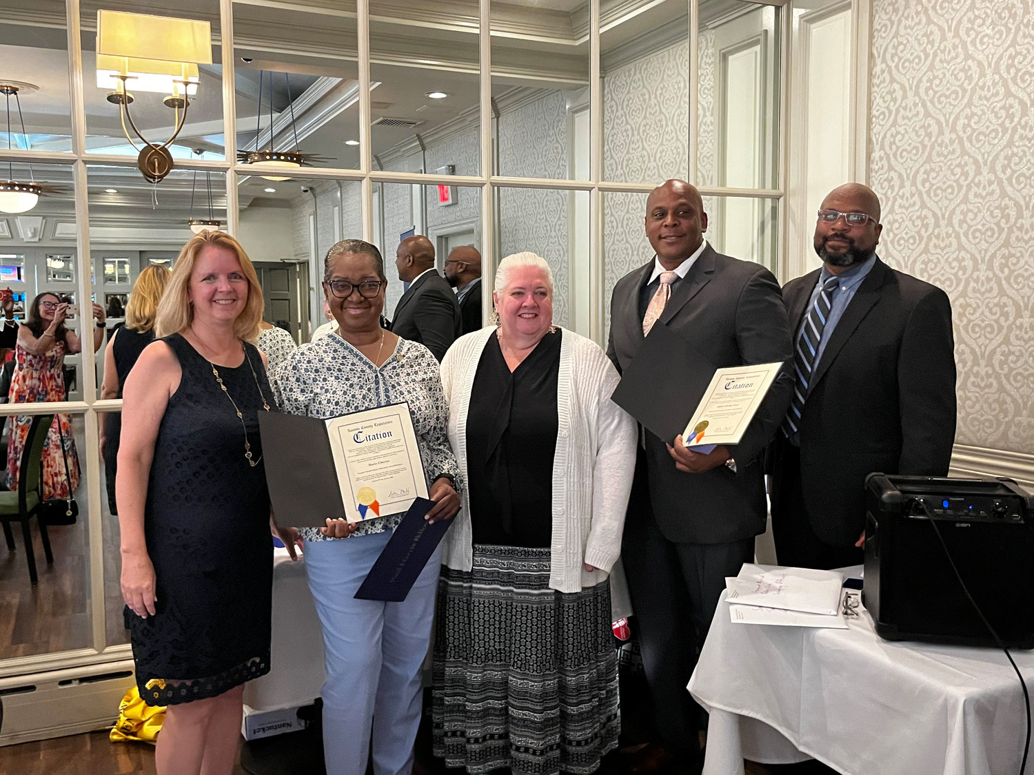 Legislature Debra Mulé, Past District Governor Mary Ellen Ellwood, and past president Marc Rigueur congratulated newly elected Rotary treasurer Marie Charles and Freeport Police Officer Bobby Ford for receiving the club’s prestigious Paul Harris Award.