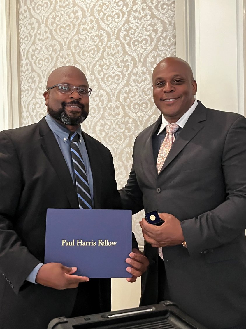 Marc Rigueur, left, Immediate Past President of the Freeport-Merrick Rotary Club, ceremonially awarded Freeport Police Officer Bobby Ford the Paul Harris Fellow Award, the Rotary's highest award for community service.