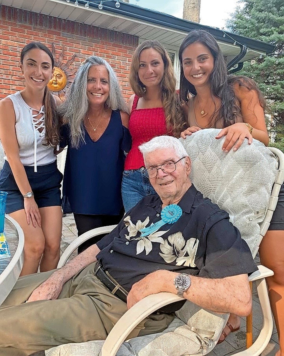 Thomas Nola, center, celebrated his 100th birthday after beating Covid-19 and a cardiac event in late 2021. His daughter Francine Castagna, second from left, and granddaughters, from left, Nicole, Gianna and Brianna surprised him with a party.