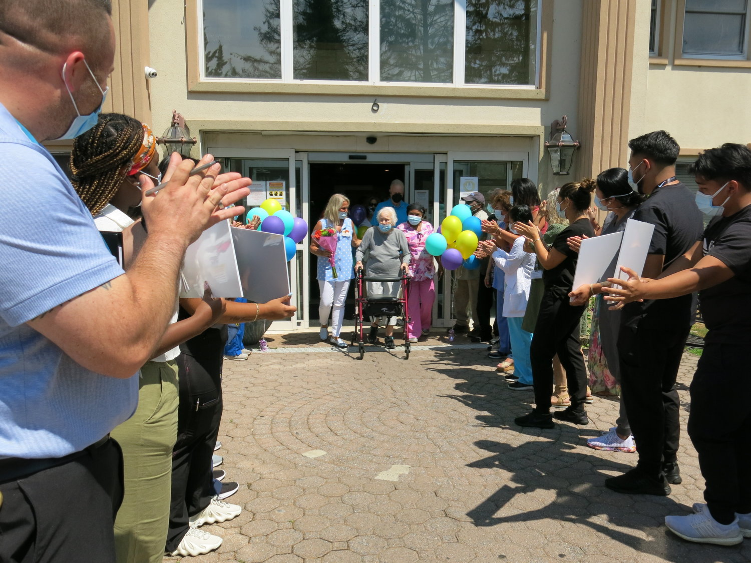 Doctors, therapists and staff lined up to celebrate Nancy Casale, 95, as she left Glen Cove Center for Nursing and Rehabilitation on July 15. She beat Covid and overcame post-Covid symptoms.