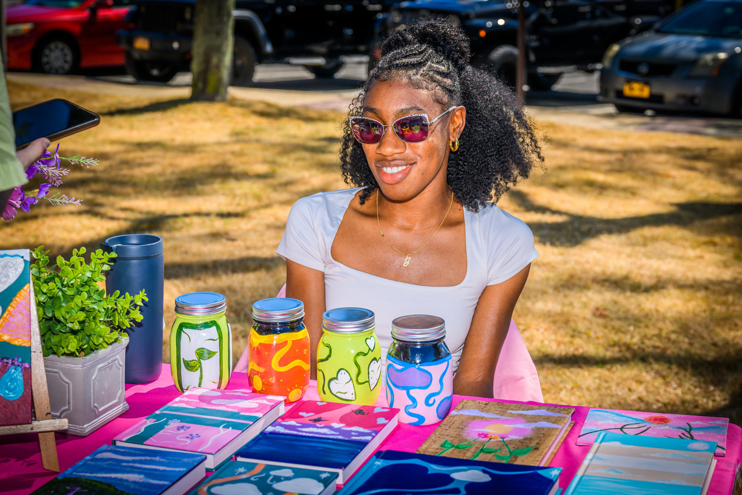 Janelle DeSouza, 26, was among about 15 artists who displayed their work at Arts in the Plaza last Saturday morning. DeSouza is a self-described expressionist.