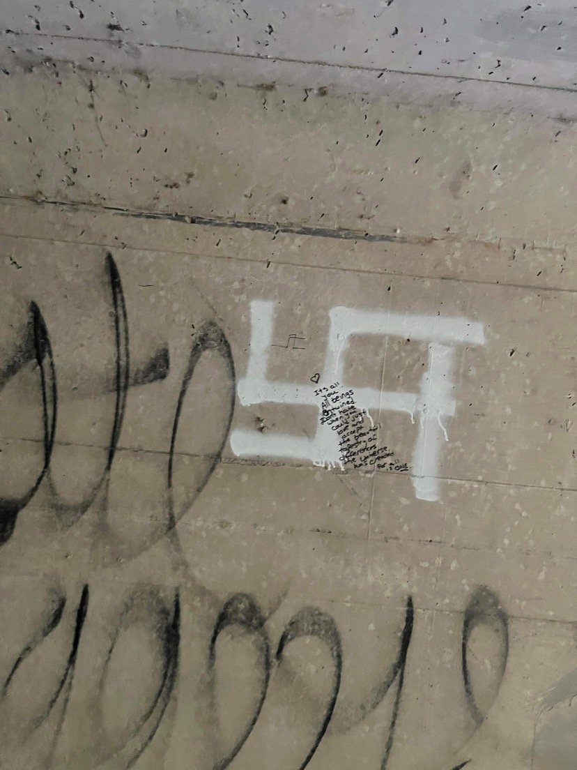 This swastika, along with several racial epithets and antisemitic profanity, was found in a tunnel in Forest City Community Park. A message of love was written over the swastika.