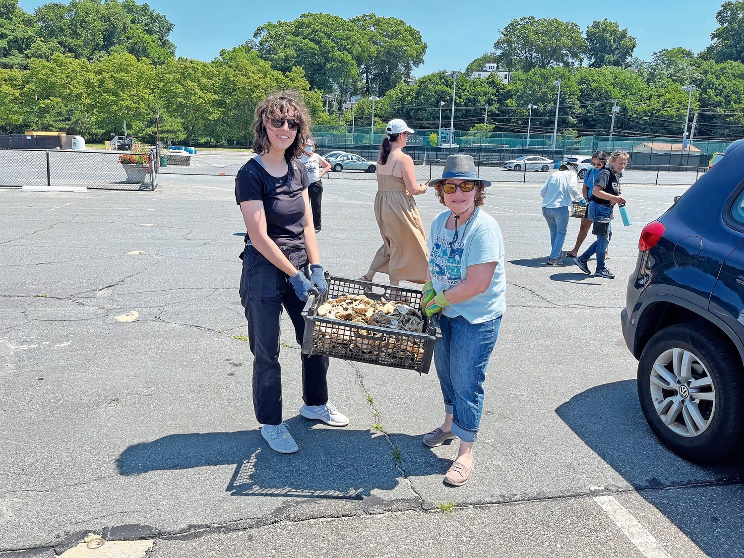 Martha Braun, left, and Carol DiPaolo carried the fresh oysters to the docks at Tappen Marina.
