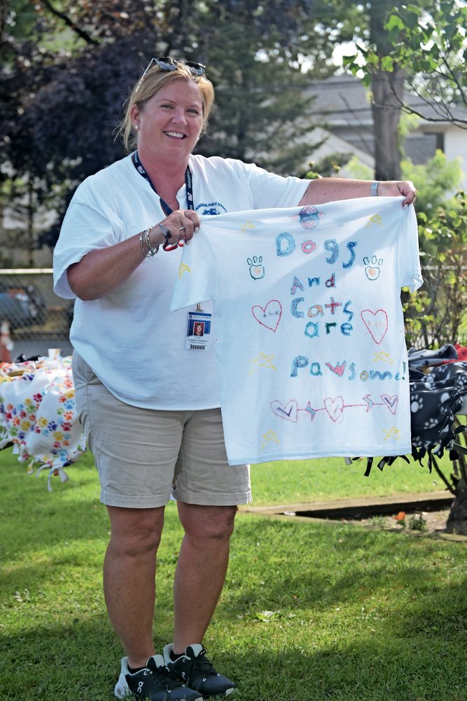 Ogden Elementary School Assistant Principal Elizabeth Murray held one of the T-shirts the campers made for the animals.