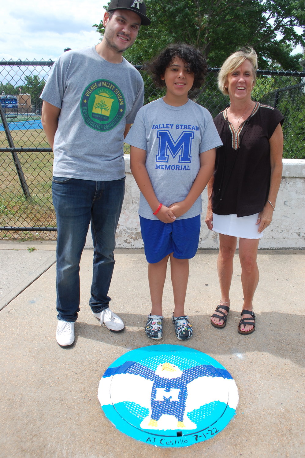 Memorial 8th grader AJ Castillo, center, with Valley Stream Beautification Committee Chairman, Kevin Waszak, left, and art teacher Darla Collins.