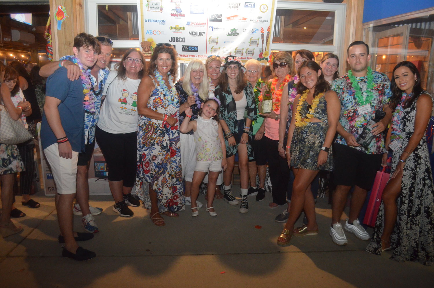 Neighbors donned their best Hawaiian leis and summer attire to support the Little Saint Nick Foundation at Dox July 28.