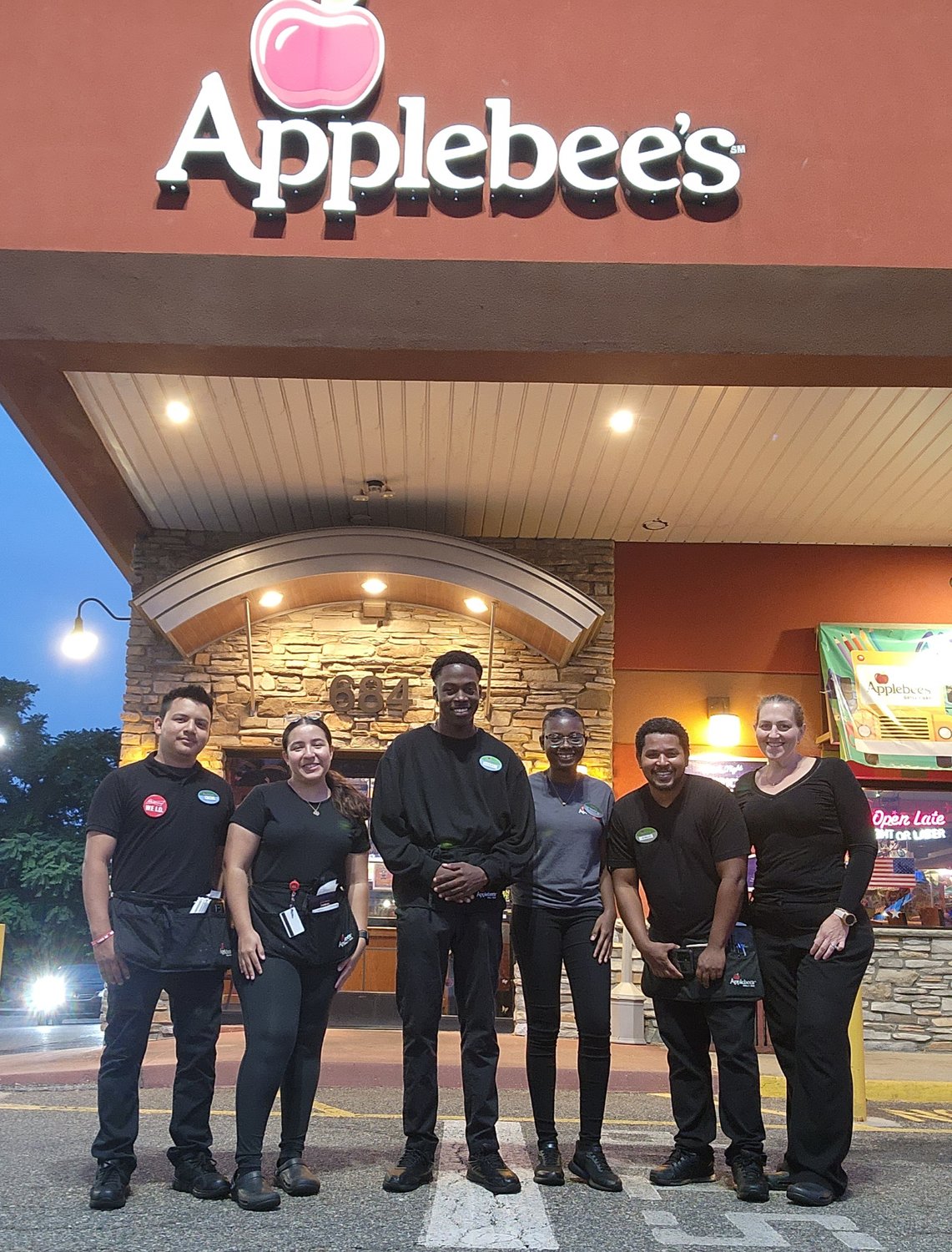 Applebee's employees Yoni Bargas, Dayana Lopez, Jonah Lissone, Abbiegayle Black, Jeanluc Etienne, and Colleen Haithman stand ready to receive school supplies next week.