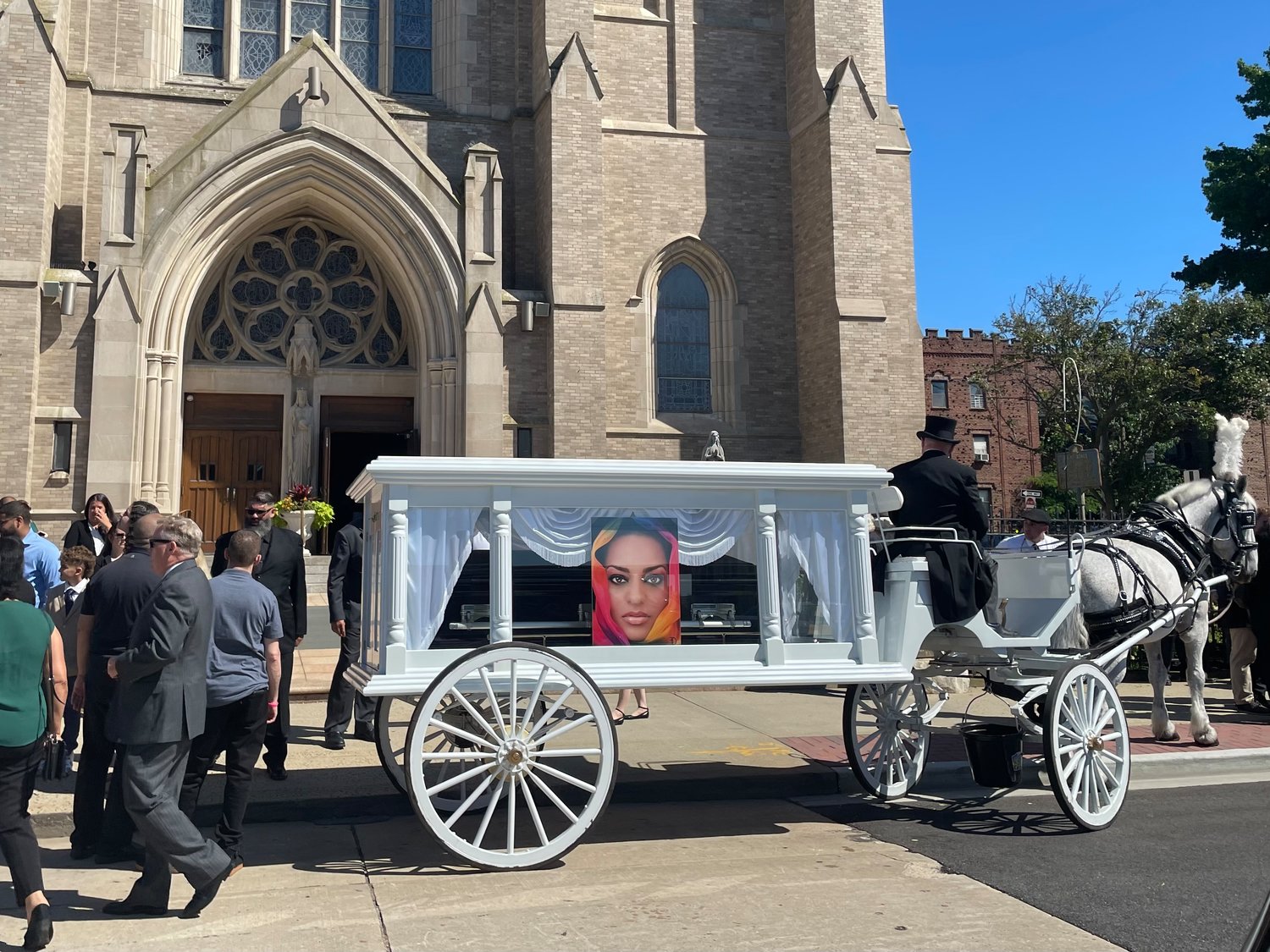 The body of Marivel Estevez was brought to St. Agnes Cathedral on a white horse-drawn hearse.