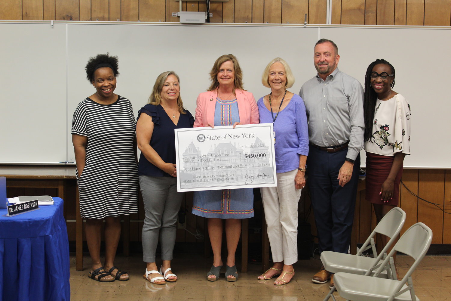 Trustee Karyn Reid, far left, education board president Susan Cools, Assemblywoman Judy Griffin, Trustee Mary Jo O’Hagan, board vice president Thomas Smyth and Trustee Annie Doresca accept the state check at the Aug. 10 meeting.