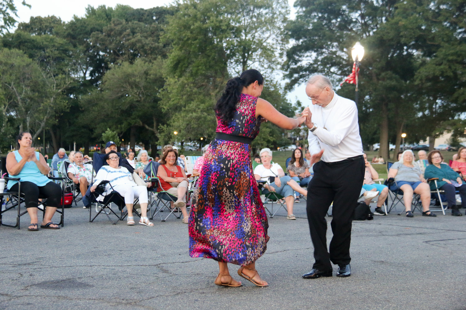 Gaetano Ferrara, known as the Mambo Man of Valley Stream, danced with partner Karina Hernandez at the Bronx Changa concert at the Village Bandshell, near left.